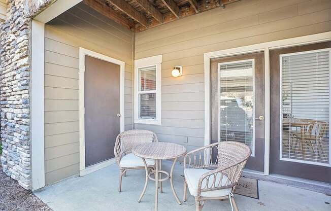 A patio with a table and chairs.