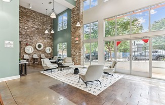 A room with a brick wall and a large window.