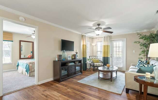 a living room with a ceiling fan and a couch