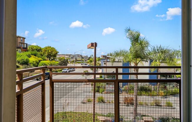 the view from the balcony of a condo overlooking a parking lot and a city