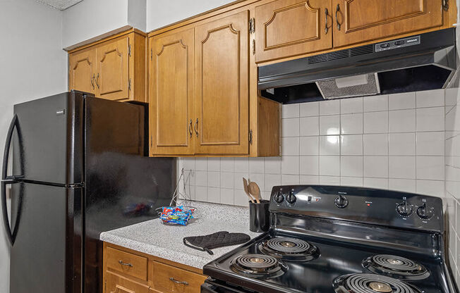 a kitchen with a stove and a refrigerator