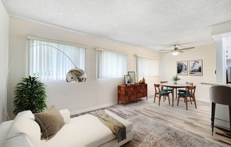 a living room and dining room with a couch and a table