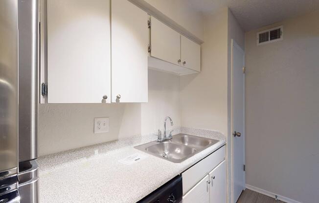 a kitchen with a sink and a mirror