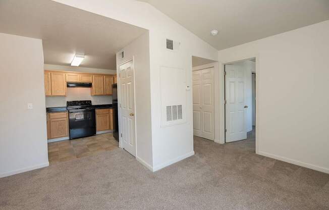 A kitchen with white walls and a black dishwasher at Autumn Oaks Apartments, Roseville, CA, 95678