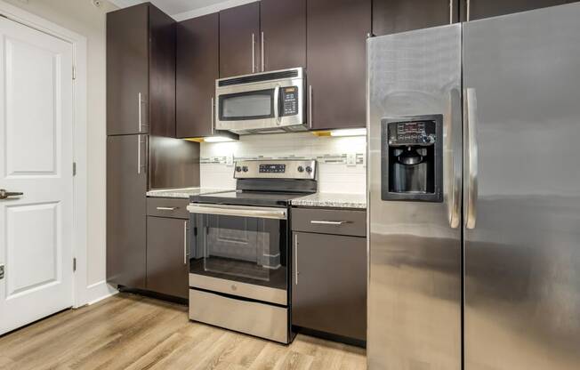 a kitchen with stainless steel appliances and a stainless steel refrigerator