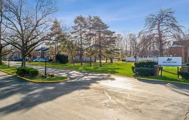 a parking lot in front of an elementary school with trees and grass