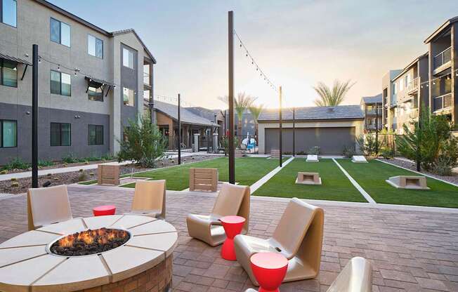 an outdoor patio with chairs and a fire pit
