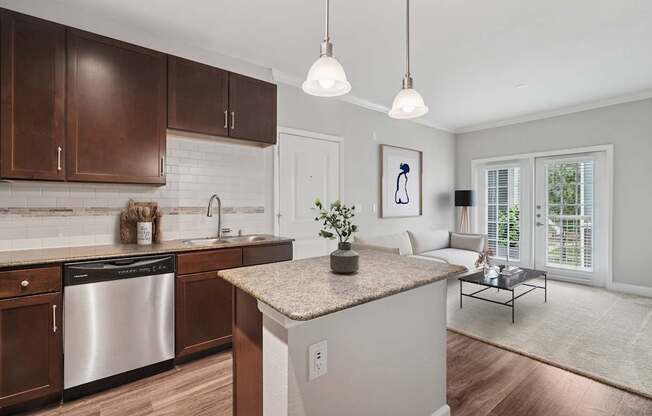 A modern kitchen with a stainless steel dishwasher and wooden cabinets.