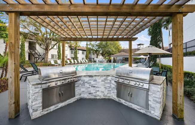 A set of grills overlooking the outdoor pool