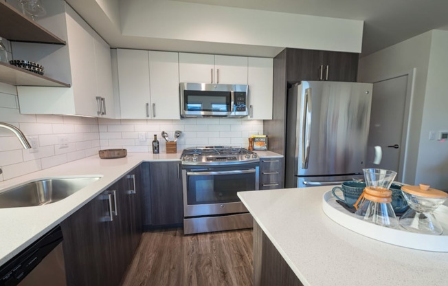 Our kitchens feature high-end finishes including stainless steel appliances and quartz countertops