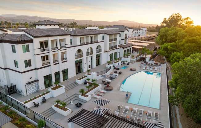 an aerial view of a hotel with a swimming pool