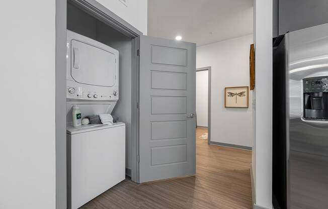 a small laundry room with a washer and dryer and a door to a