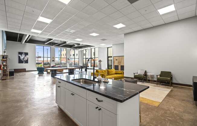 a large open space with a kitchen island and yellow couches  at The Icon, Richmond, VA