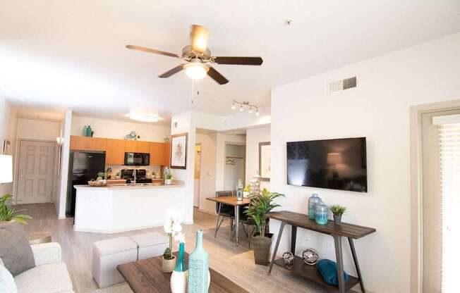 A living room with a white couch and a brown coffee table.