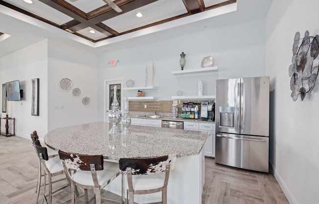 a kitchen with a marble counter top and stainless steel appliances