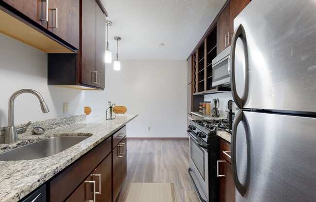 a kitchen with wood cabinets and granite countertops