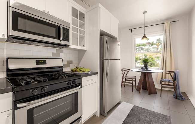 a kitchen with stainless steel appliances and a stainless steel refrigerator at Del Mor Apartments, Los Angeles, CA