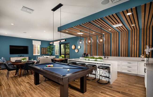 a living room with a pool table and a dining room