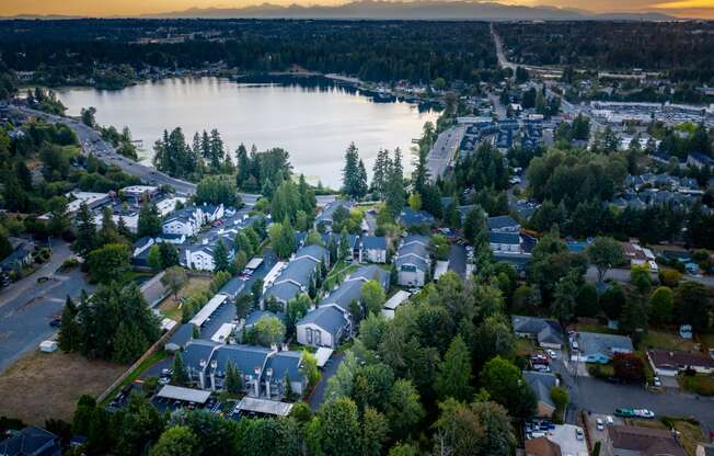 arial view of a neighborhood with a lake in the background