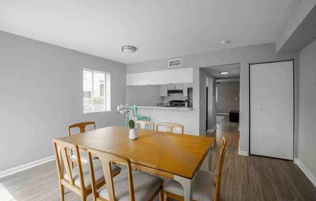 a dining room with a wooden table and chairs