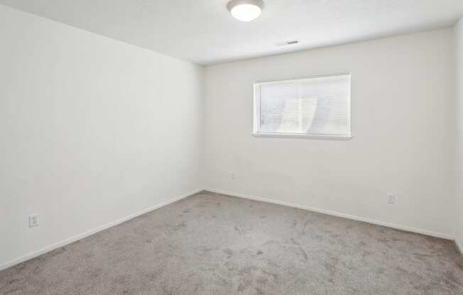 the living room of an empty house with a window