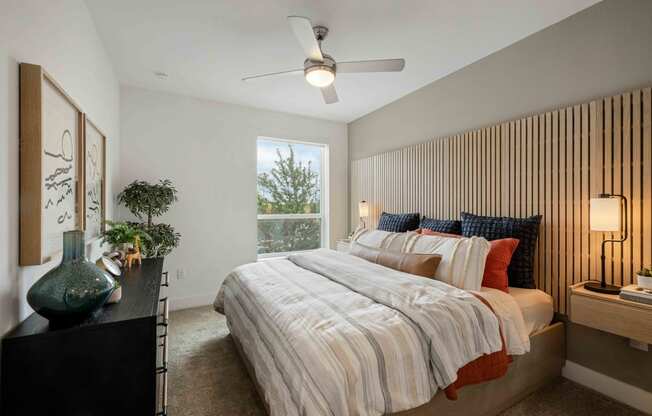 a bedroom with a bed and a ceiling fan