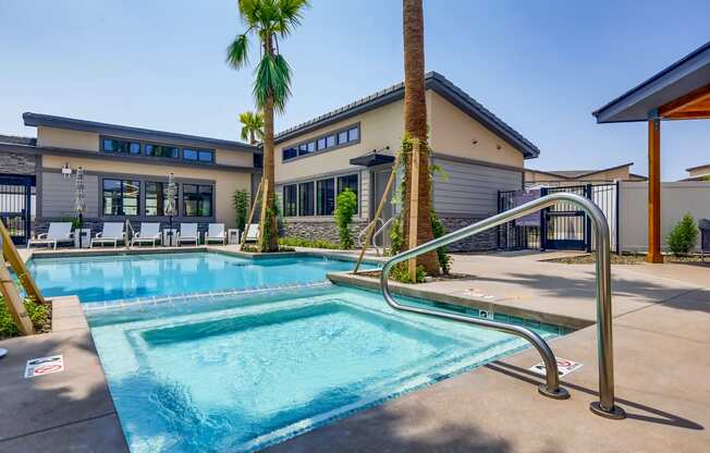 a swimming pool with a building in the background at Grandstone at Sunrise, Peoria