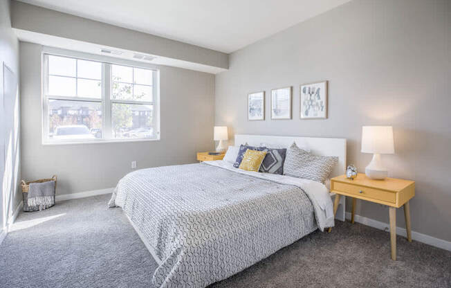 Bedroom with large windows at Ascend at Woodbury new luxury apartments in Woodbury MN 55129