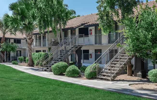 a building with stairs and trees in front of it