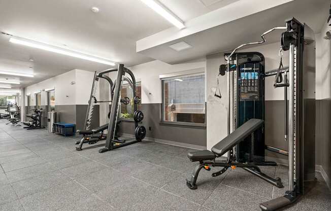 A gym with a variety of equipment including a leg press machine.