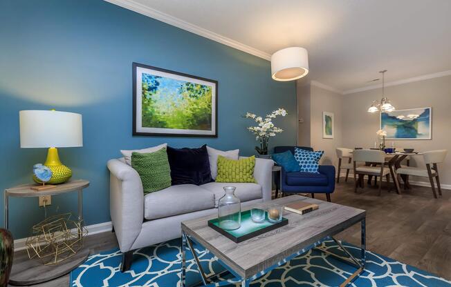 A furnished living room and set dining table at Ashley Oaks Apartments in Greensboro, North Carolina