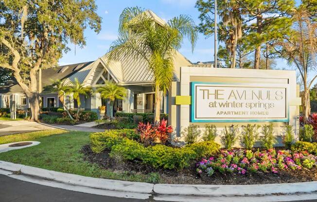 the sign in front of a building with palm trees