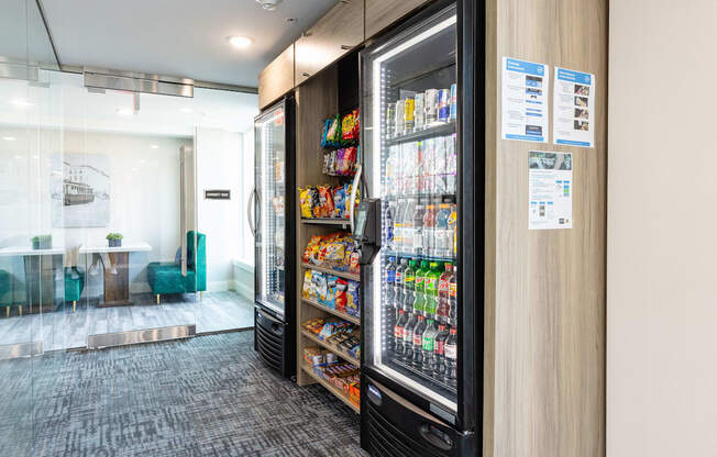 A vending machine with a variety of snacks and drinks inside a modern office space.