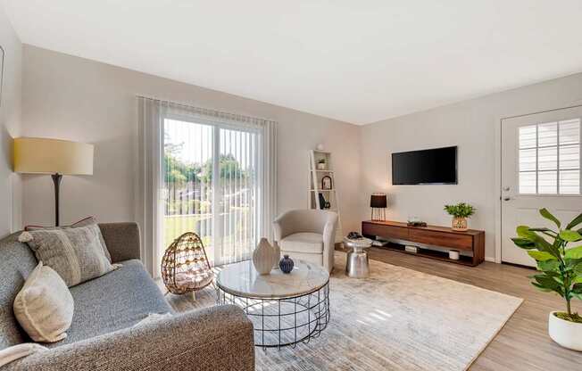 a living room with a couch and a chair and a tv