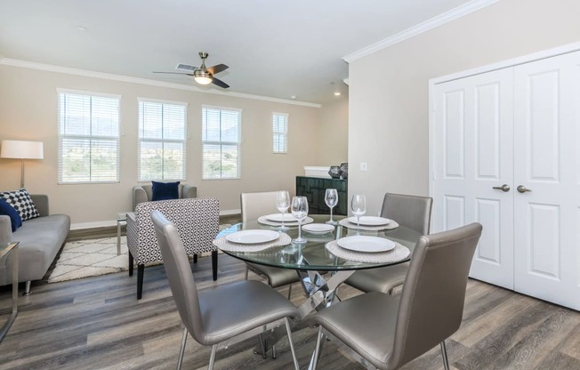 a dining room with a glass table and chairs