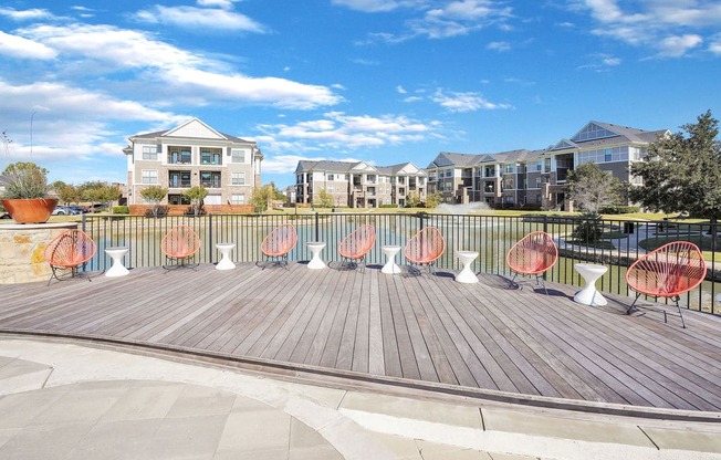 orange lounge chairs sitting on a wooden deck