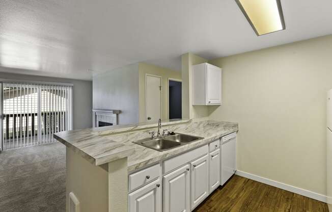 Spacious Kitchen with living room view and wide outdoor windows at Serra Vista Apartment Homes, Lynnwood, Washington 98087