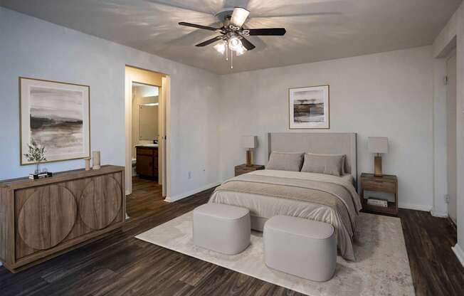 A bedroom with a bed, nightstands, and a ceiling fan.