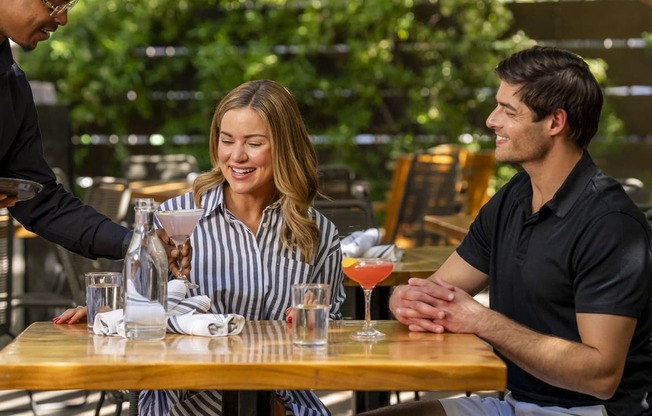 a man and woman sitting at a table with drinksat AVE Phoenix Sky, Phoenix, 85003