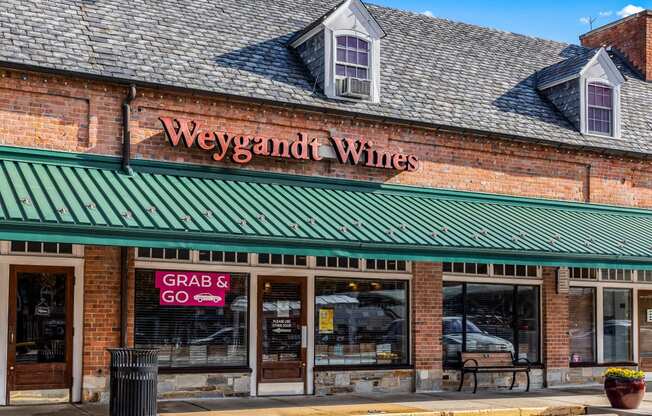 a brick building with a green roof and a sign that reads wings