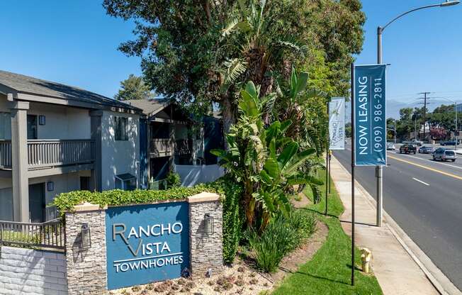 A sign for Rancho Vista Townhomes is displayed in front of a building.