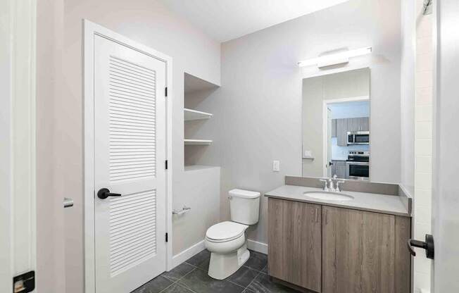 a bathroom with a toilet sink and a mirror