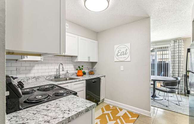 A kitchen with a marble countertop and a sign that says