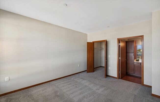 bedroom with a carpet and a door in it