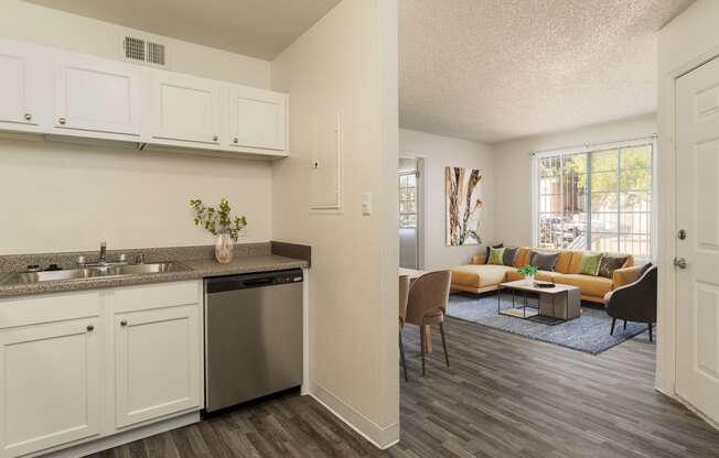 an open kitchen and living room with a couch and a table