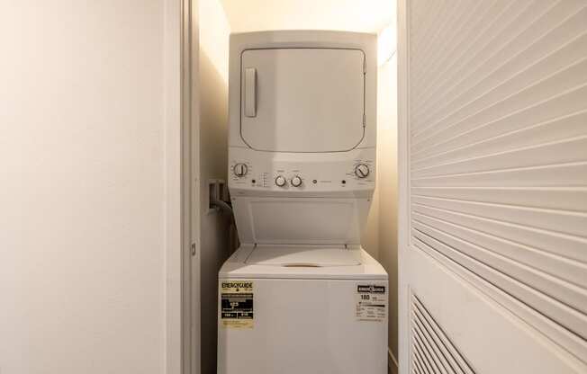 a white washer and dryer in a closet