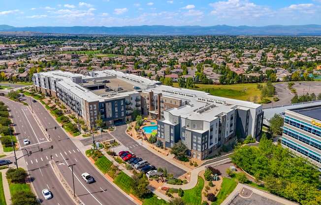 an aerial view of a city with buildings and a swimming pool