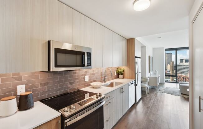 a kitchen with white cabinets and a sink and a microwave at Cassidy on Canal, Chicago, IL, 60654