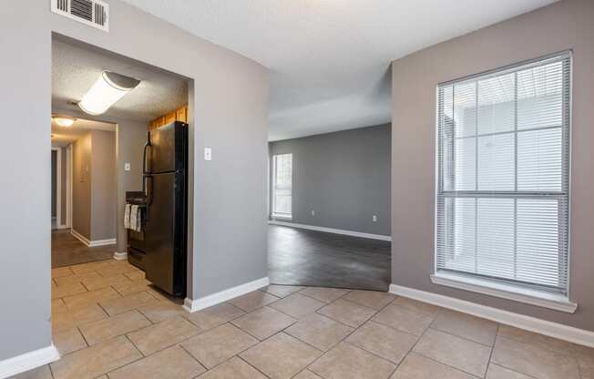 Westchase Apartments in Harvey LA photo of an empty living room with a large window and tile flooring