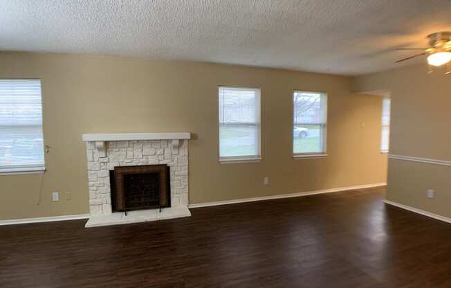 living room with wood floors and fireplace